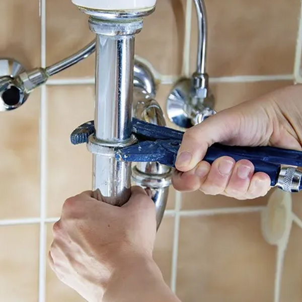 Plumber fixing bathroom pipe