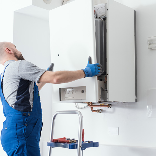 Professional engineer doing a boiler inspection at home